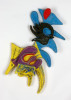 A close up of two different colored pins