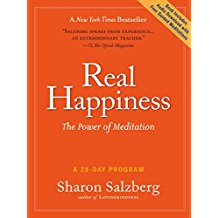 A book cover with an orange background and the words " real happiness ".