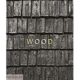 A close up of the word wood on a wooden shingle wall.