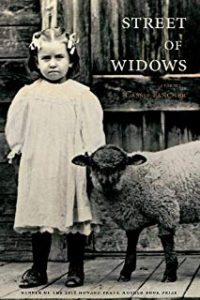 A young girl standing next to a sheep.