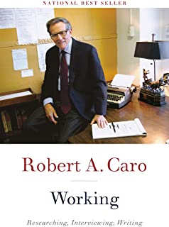 A man sitting at his desk in front of papers.