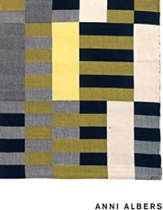 A black, white and yellow quilt with a geometric design.