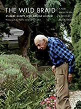 A man in plaid shirt looking at plants.