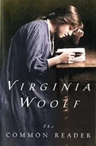 A woman sitting at a table with a book.