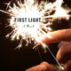 A person holding sparklers with the words " first light " written on them.