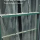 A green metal door with some type of window.