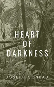 A black and white photo of trees with the words " heart of darkness ".