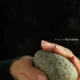 A person holding a rock in their hand.