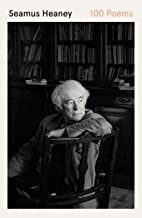 A black and white photo of an older man in front of bookshelves.