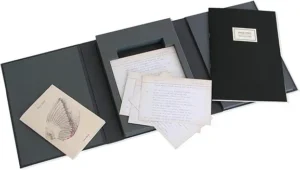 A black and white photo album with some papers