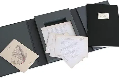 A black and white photo album with some papers